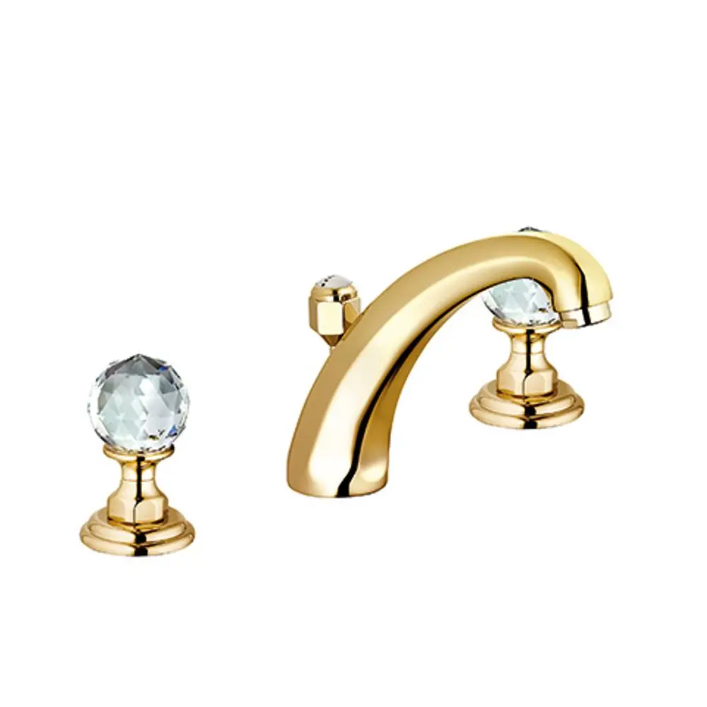 Waschtischarmatur von Kludi für Dreilochmontage in gold mit kristallähnlichen Griffen. Die Armatur hat eine geschwungene Form.